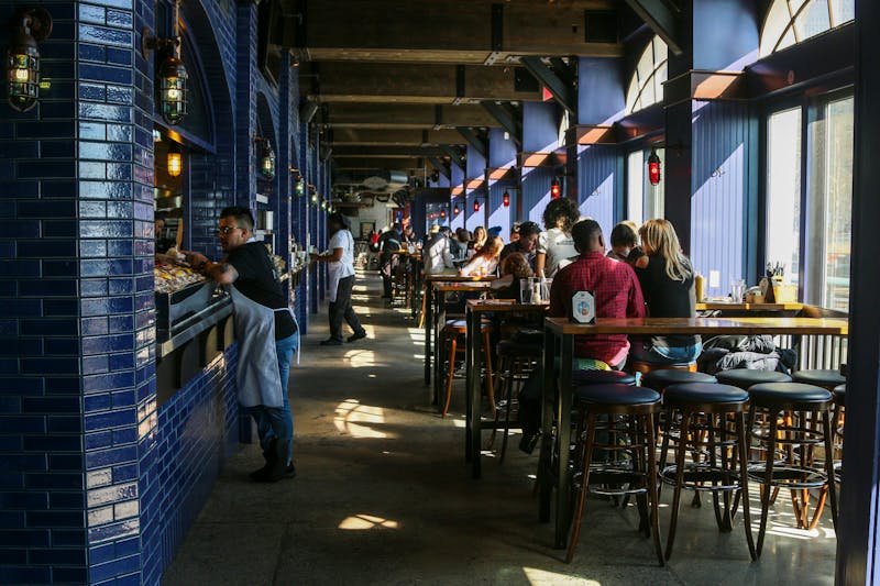 Dewey's Pizza kitchen team preparing fresh pizzas together